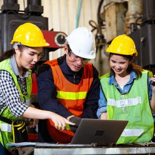 Asian engineer or technician man foreman training female trainee using program or system in industry manufacturing factory. teamwork and corporate people working hard in industrial construction site